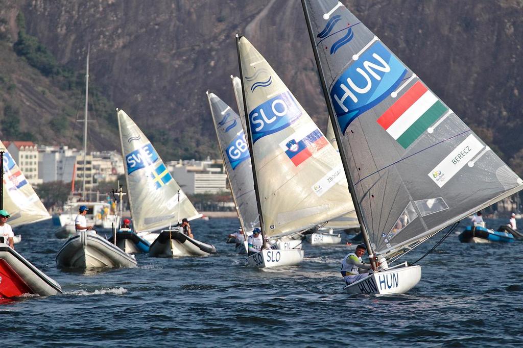 Finn fleet returns from a wearying day’s racing on the inshore course under the Sugar Loaf - Day 2 © Richard Gladwell www.photosport.co.nz